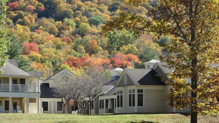 View of the facility with colorful trees in the background