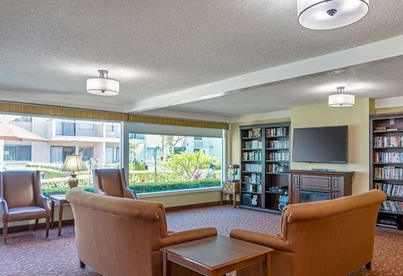 Comfortable common area with seating and bookshelf