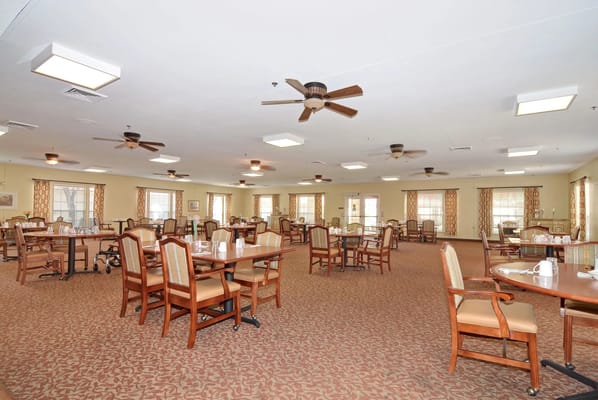 Bright and spacious dining room with tables and decorated windows