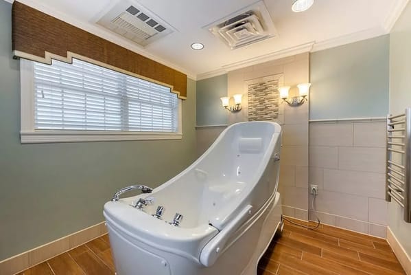 A modern assisted living bathroom with a bathtub