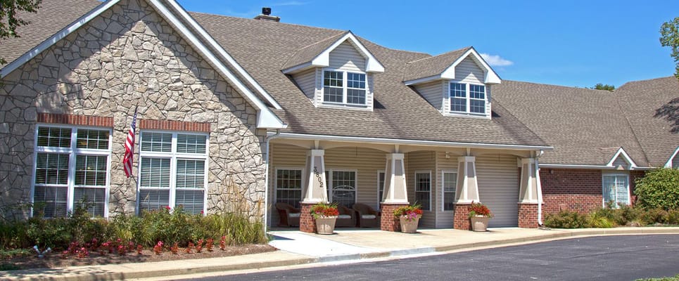 Exterior view of a senior living building with landscaping