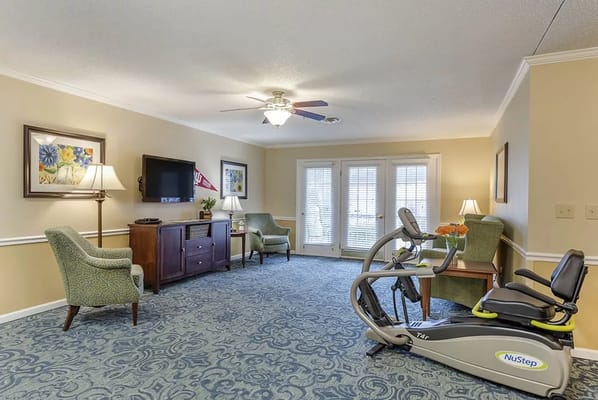 Interior common area with exercise equipment and seating