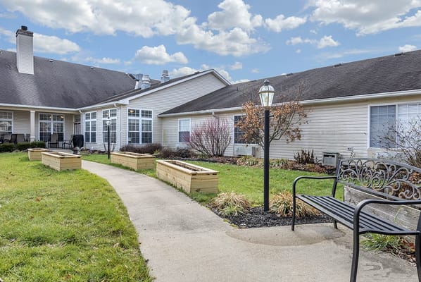 Pathway through landscaped garden area with seating