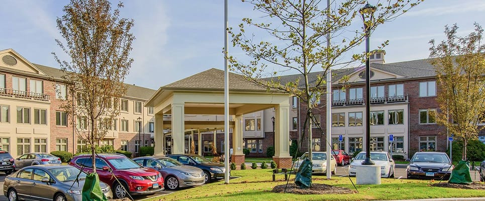 Front entrance of a senior living facility with parking