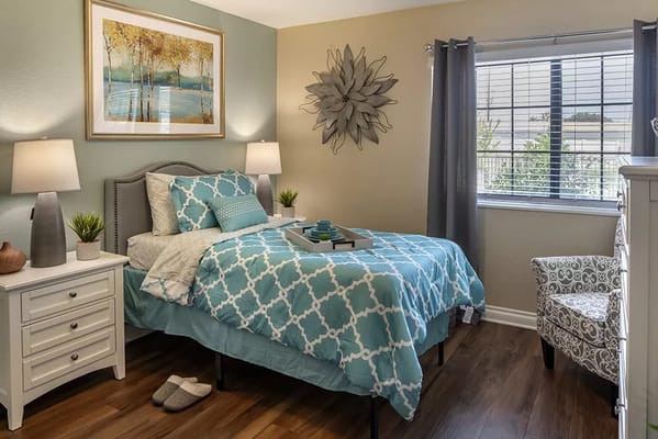 Cozy resident room with blue bedding and decorative art