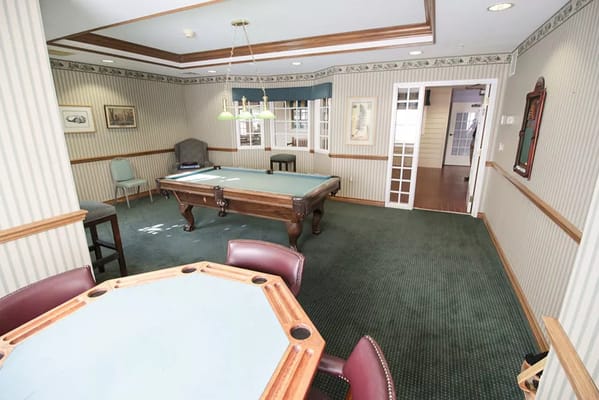 Interior activity room with pool table and seating