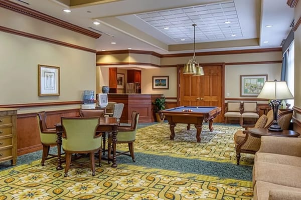 Interior view of a cozy common area with furniture and pool table
