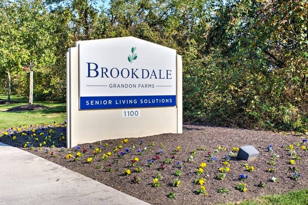 Sign for Brookdale Grandon Farms with flowers