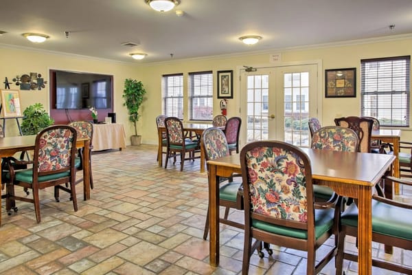 Interior dining room area with floral chairs and tables