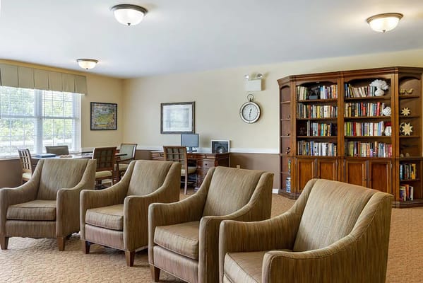 Cozy common area with armchairs and bookshelves