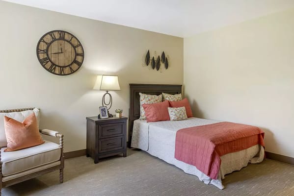 A cozy resident room with a bed and decorative items