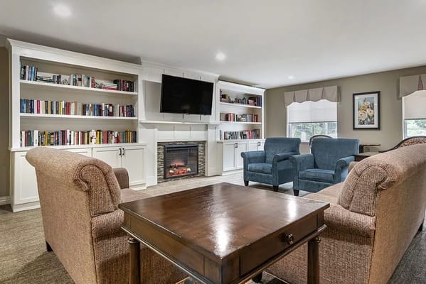 Interior view of a cozy common area with bookshelves