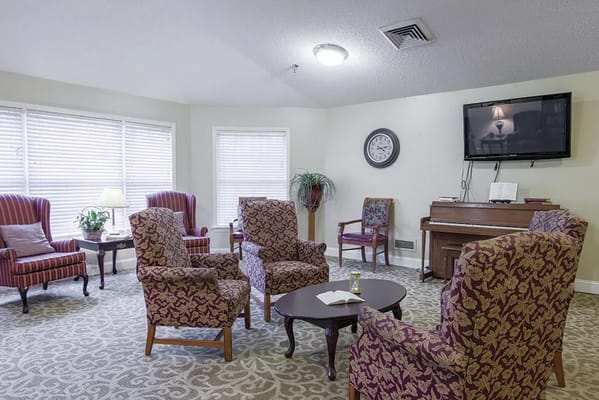 Cozy common area with seating and a piano