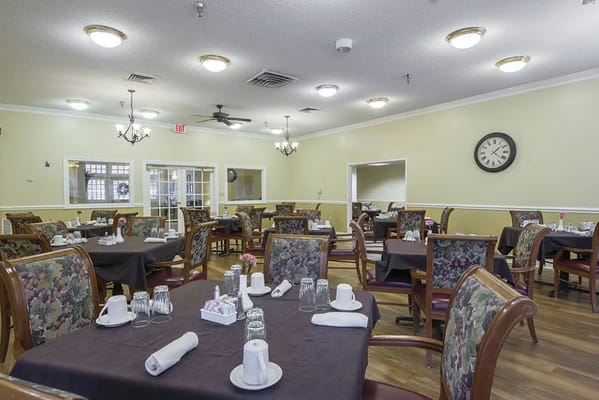 Dining room with tables set for residents