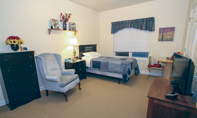 Cozy private resident room with bed and furnishings