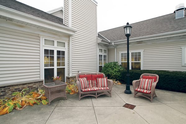 Outdoor seating area with chairs and plants
