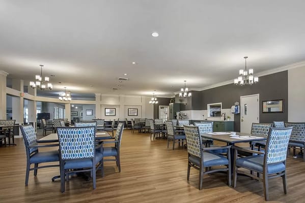 Dining area with tables and chairs in bright lighting
