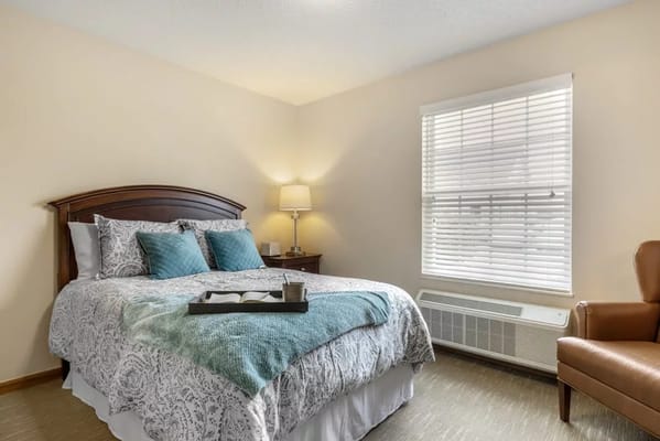 Well-furnished bedroom in a senior living facility