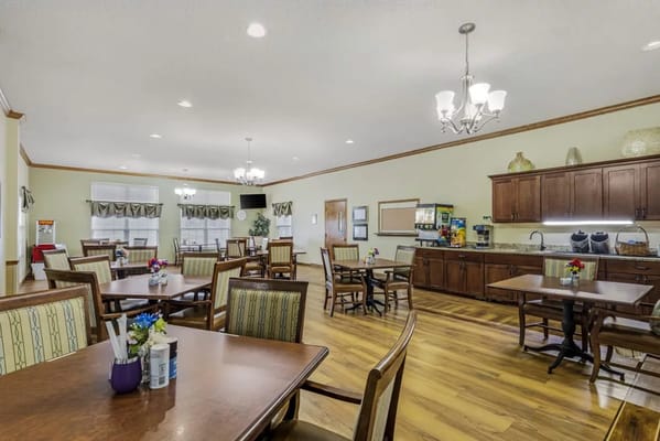 Dining room with tables and chairs set for residents