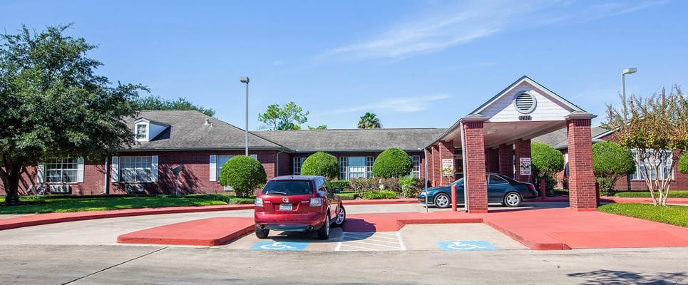 Front entrance of a senior living facility with landscaped area