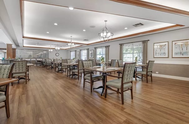Bright dining area with wooden floors and ample seating