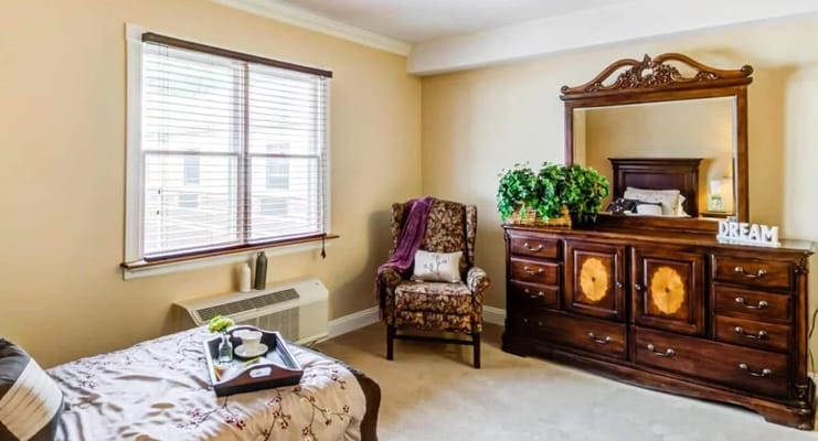 A cozy resident room with furniture and decor