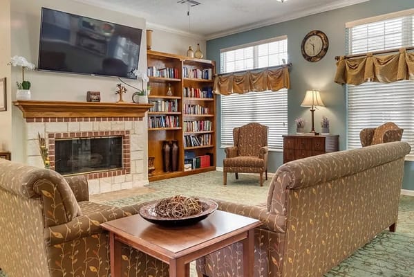 Cozy common area with seating and bookshelf
