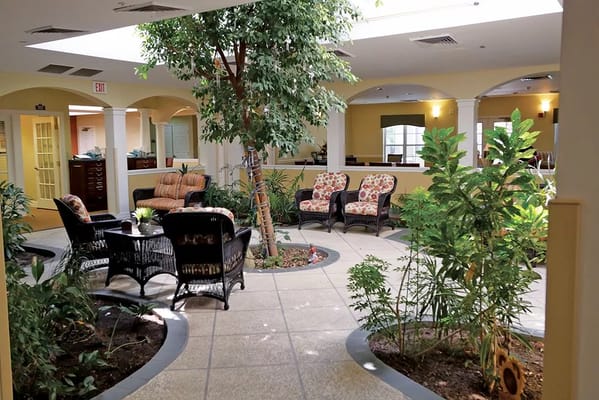 Common area with seating and plants in a nursing home