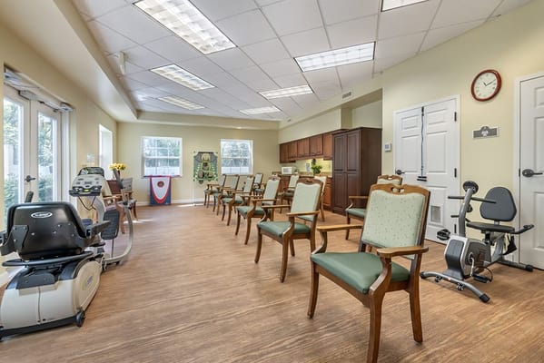 Interior view of a common area with chairs and exercise equipment
