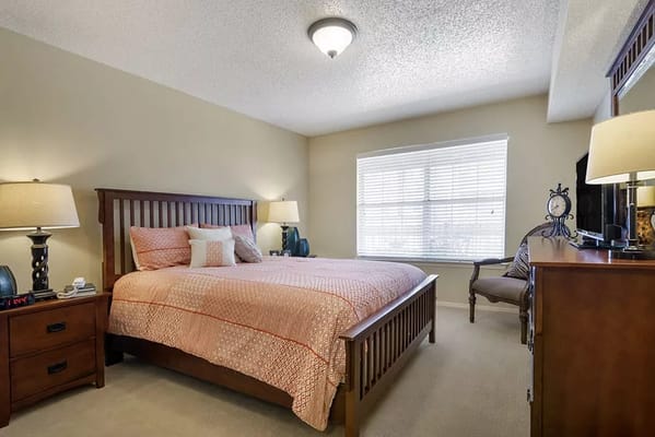 A cozy private resident room with a bed and natural light