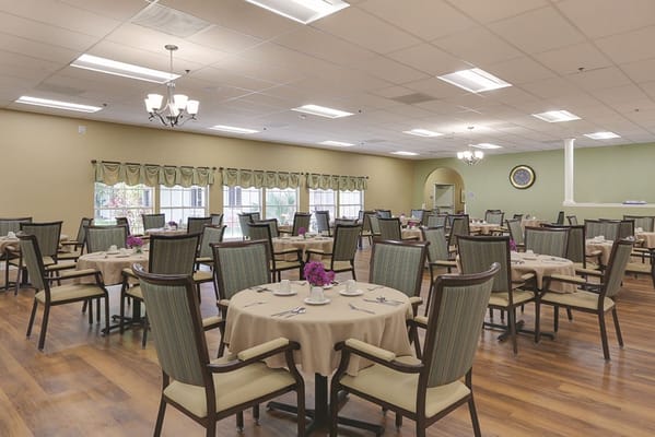 Dining room with tables and chairs set for meals