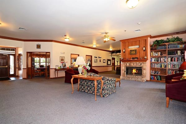 Cozy common area with bookshelves and fireplace
