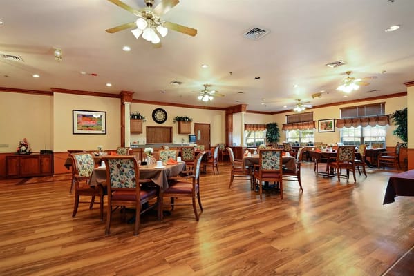 Bright dining room with tables set for meals