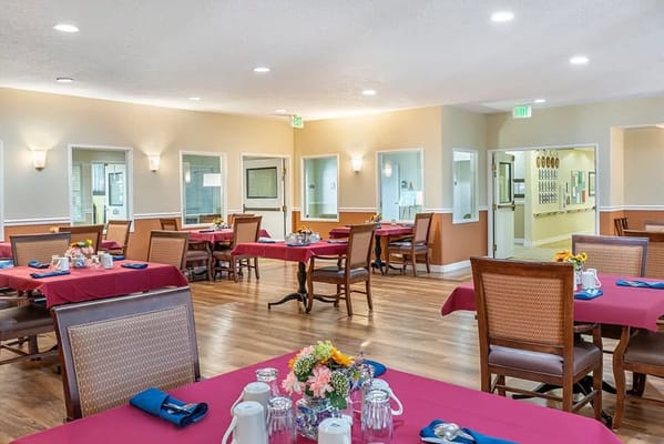 Dining area with tables and flowers arranged.