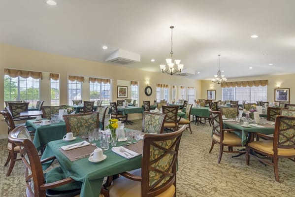 Dining area set for residents with flowers on the table