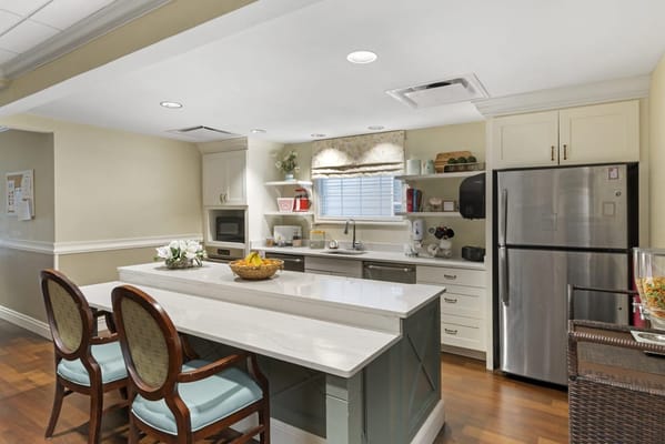 Bright kitchen area with modern appliances and seating