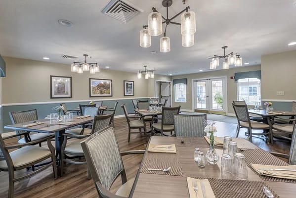 Elegant dining area with tables set for residents