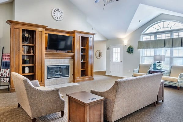 Warm common area with seating and fireplace