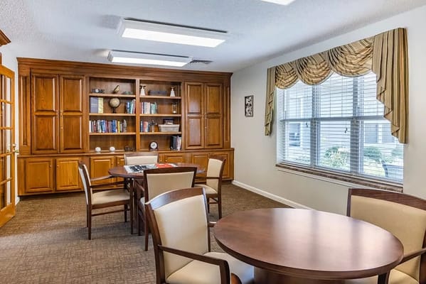 Cozy common area with wooden bookshelves and seating
