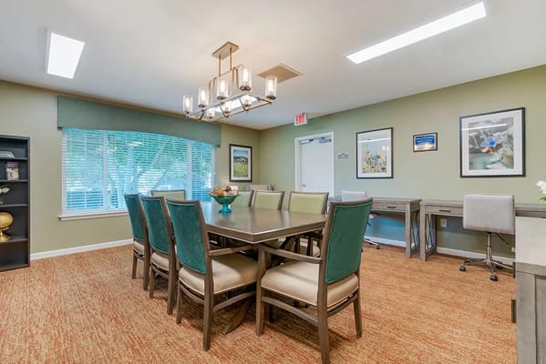 Bright common area with a large table and chairs