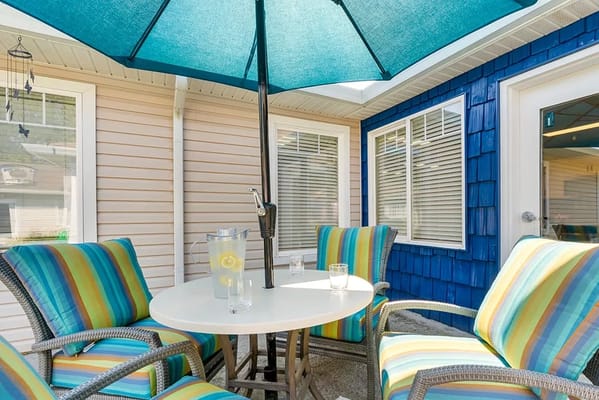 Outdoor seating area with colorful chairs and a table