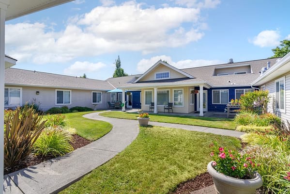 Garden pathway with seating and flower beds