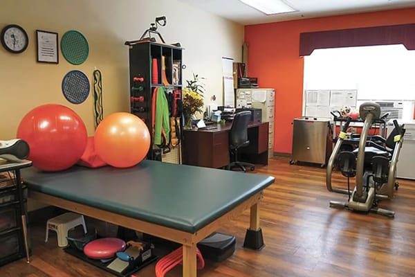 Therapy room with exercise equipment and colorful balls