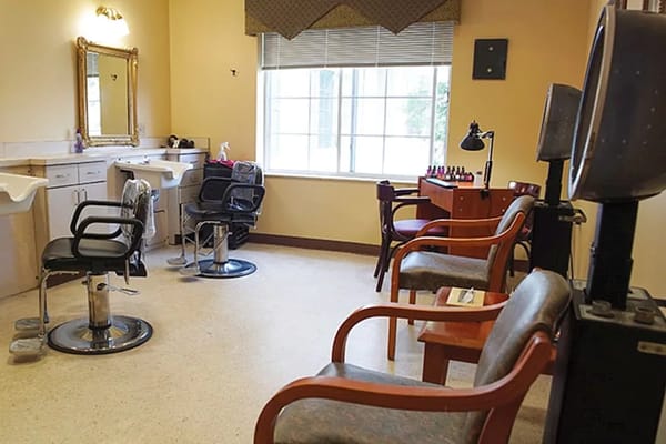 A hair salon area with styling chairs and mirrors