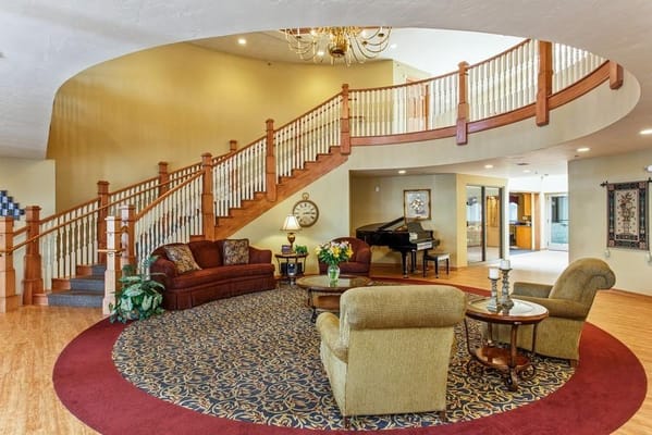 Cozy lobby with staircase and seating area at Brookview Meadows