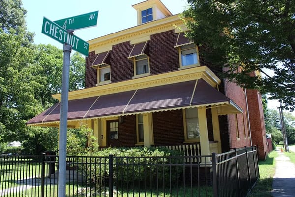 Exterior view of a red brick building with yellow accents