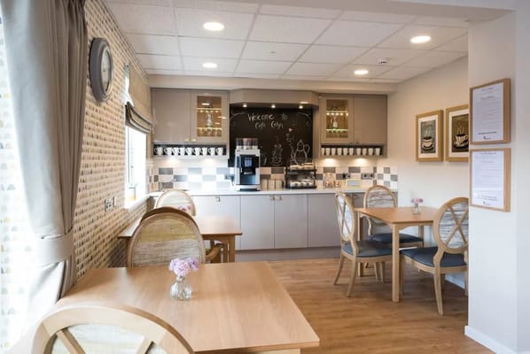 Bright dining area with tables and coffee station