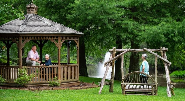 Residents enjoying time in a gazebo in the garden