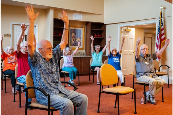 Residents participating in a seated activity in a common area