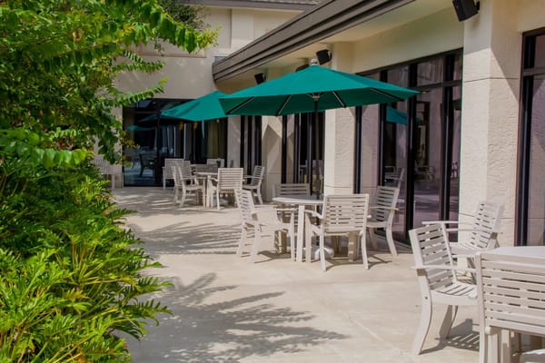 Outdoor patio area with tables and umbrellas